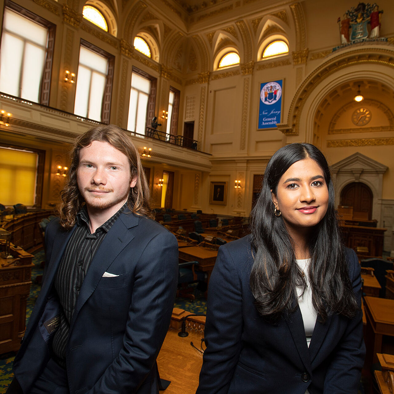 Two students sitting in legislative chambers image number 0